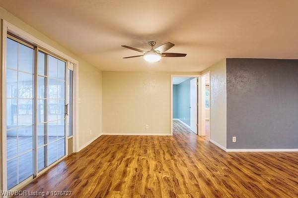 unfurnished room with hardwood / wood-style floors and ceiling fan