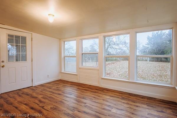 unfurnished sunroom with lofted ceiling