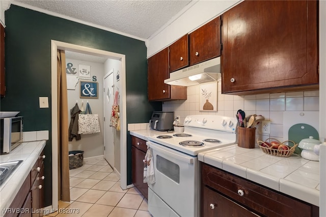 1008 Pattie Ln, Barling, AR 72923 - kitchen featuring white electric range oven, under cabinet range hood, a textured ceiling, light tile patterned floors, and decorative backsplash