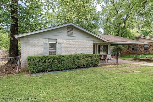 1008 Pattie Ln, Barling, AR 72923 - view of side of property with brick siding, a carport, and a patio