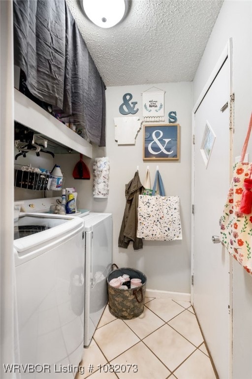 1008 Pattie Ln, Barling, AR 72923 - laundry room featuring washer and clothes dryer, a textured ceiling, and tile patterned flooring