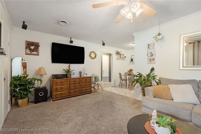 1008 Pattie Ln, Barling, AR 72923 - carpeted living room with a textured ceiling, ceiling fan, and tile patterned flooring