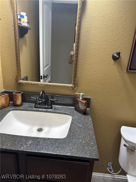 bathroom featuring toilet and vanity