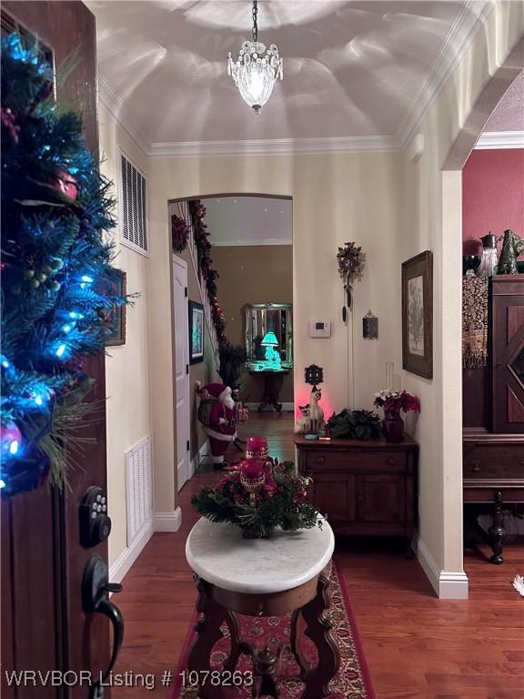 21 Bermuda Ct, Mountain Home, AR 72653 - foyer featuring wood finished floors, crown molding, baseboards, and a chandelier