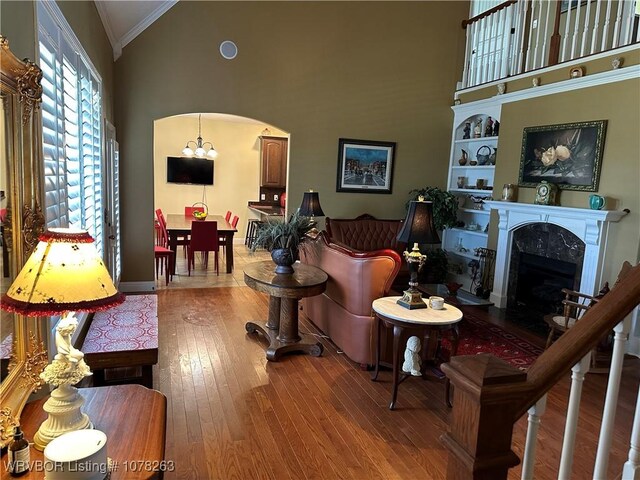 21 Bermuda Ct, Mountain Home, AR 72653 - living area with high vaulted ceiling, hardwood / wood-style flooring, arched walkways, crown molding, and a fireplace