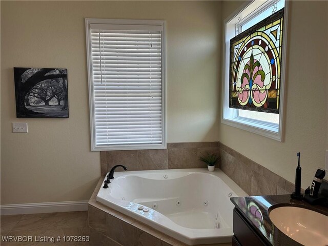 21 Bermuda Ct, Mountain Home, AR 72653 - full bathroom with a whirlpool tub, plenty of natural light, vanity, and baseboards