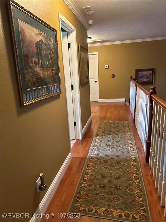 hall featuring ornamental molding and wood-type flooring