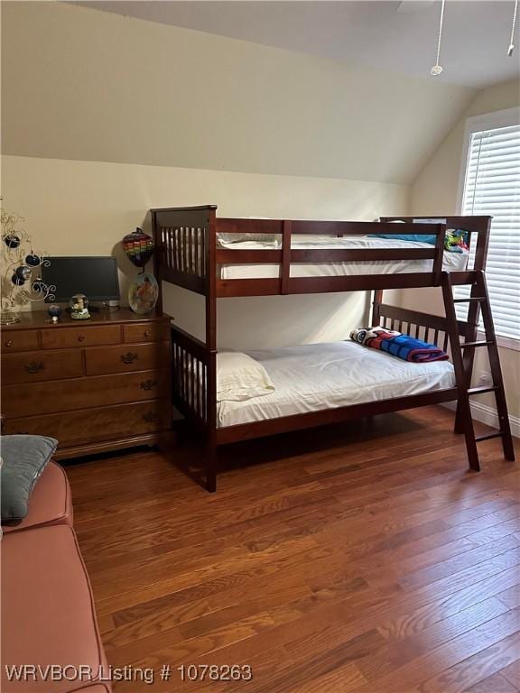 bedroom featuring vaulted ceiling and dark wood-type flooring