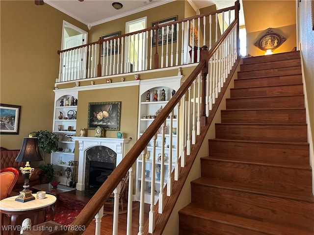 21 Bermuda Ct, Mountain Home, AR 72653 - stairs with ornamental molding, a premium fireplace, a high ceiling, and wood finished floors