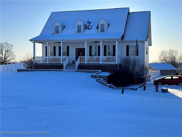 cape cod-style house featuring covered porch