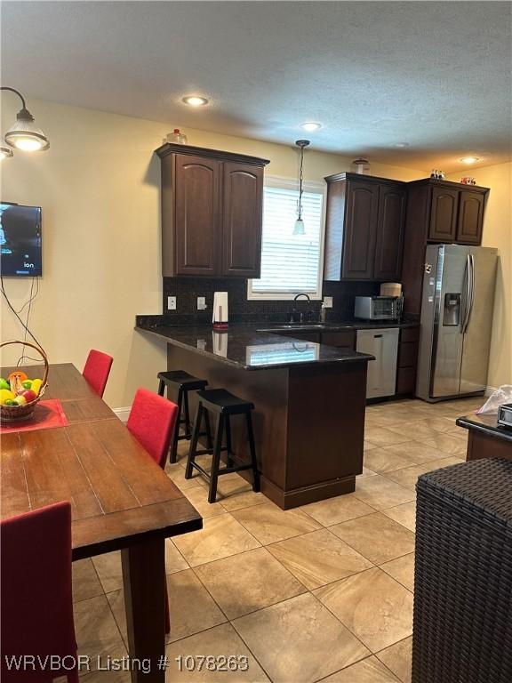 21 Bermuda Ct, Mountain Home, AR 72653 - kitchen with appliances with stainless steel finishes, a peninsula, dark countertops, dark brown cabinets, and recessed lighting