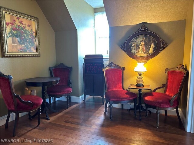 21 Bermuda Ct, Mountain Home, AR 72653 - living area with hardwood / wood-style flooring, a textured wall, vaulted ceiling, and baseboards