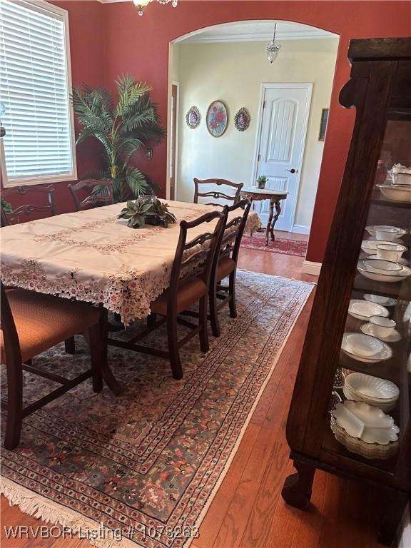 21 Bermuda Ct, Mountain Home, AR 72653 - dining room featuring arched walkways, wood finished floors, and crown molding
