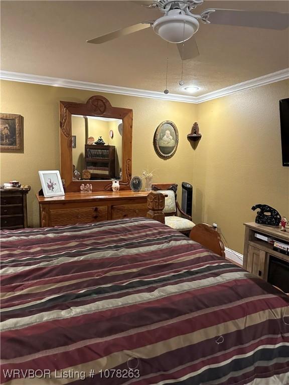 bedroom featuring ornamental molding and ceiling fan