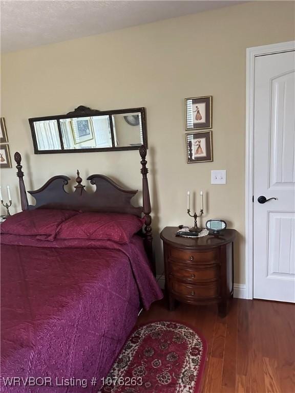 bedroom with hardwood / wood-style flooring