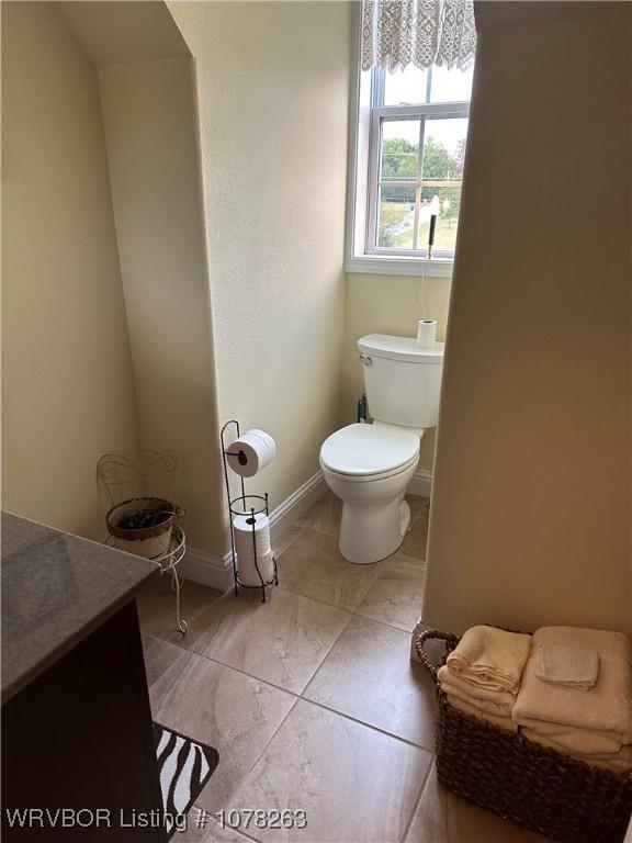 21 Bermuda Ct, Mountain Home, AR 72653 - bathroom with toilet, vanity, tile patterned flooring, and baseboards