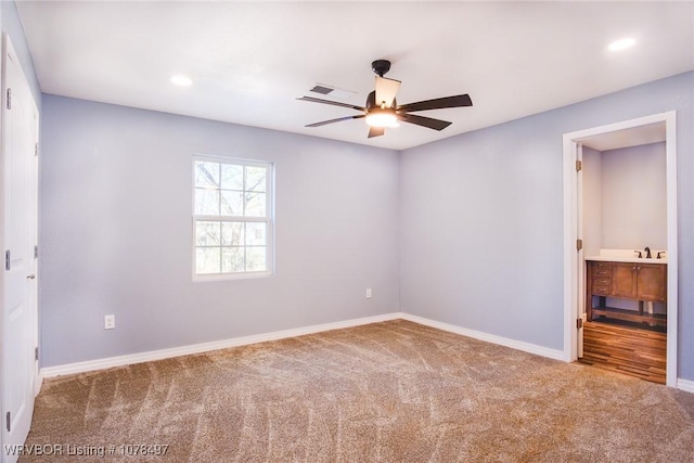 unfurnished bedroom with ceiling fan, connected bathroom, and carpet floors