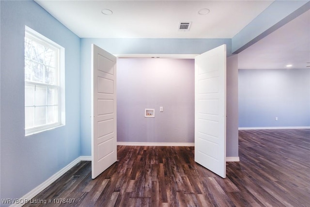 interior space featuring washer hookup and dark hardwood / wood-style floors