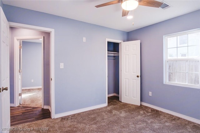 unfurnished bedroom with carpet flooring, ceiling fan, and a closet