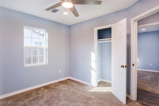 unfurnished bedroom featuring carpet flooring, ceiling fan, and a closet