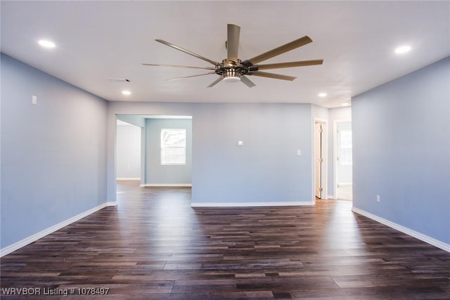 empty room featuring ceiling fan and dark hardwood / wood-style flooring