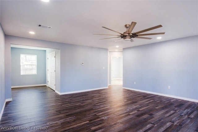 spare room featuring dark wood-type flooring and ceiling fan