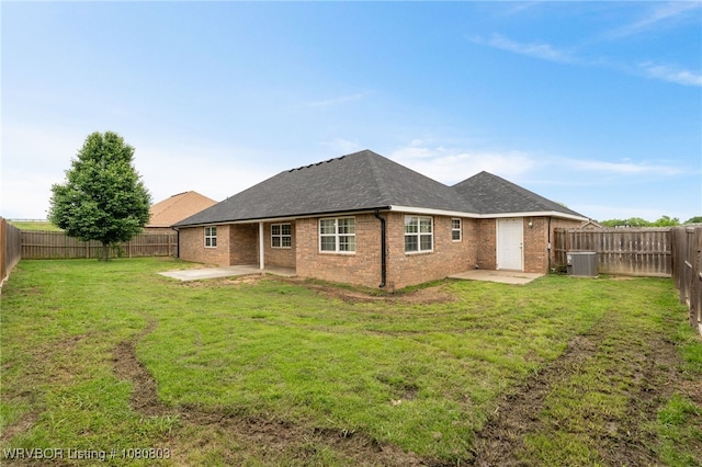 rear view of property with a patio, central air condition unit, brick siding, and roof with shingles