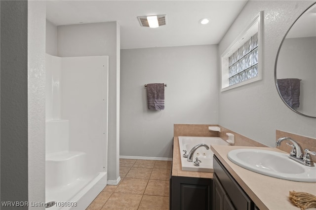 full bathroom featuring tile patterned floors, a garden tub, vanity, a shower, and baseboards