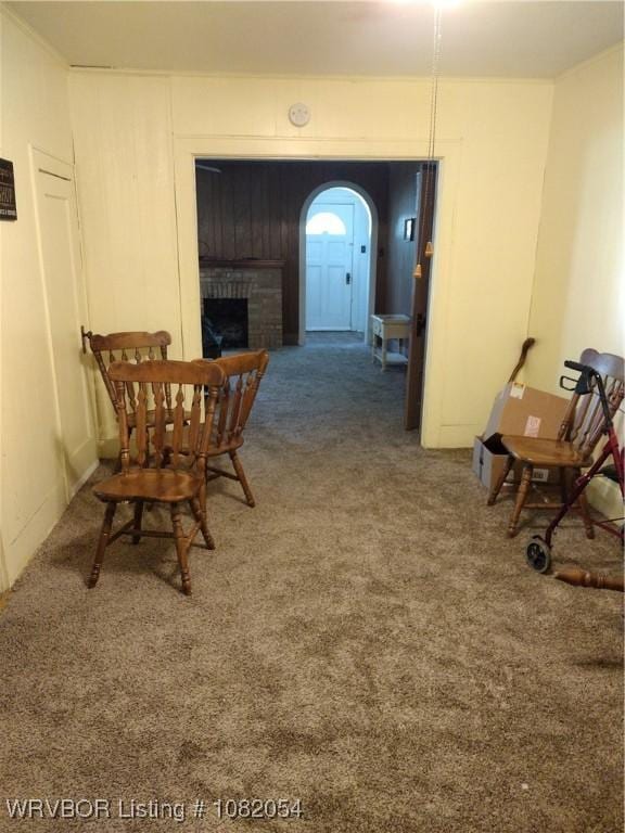 122 N Logan St, Charleston, AR 72933 - dining room with arched walkways, carpet floors, and a brick fireplace
