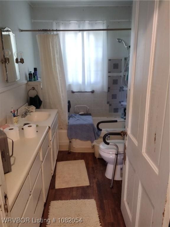 122 N Logan St, Charleston, AR 72933 - full bathroom with wood finished floors, shower / tub combo with curtain, and vanity