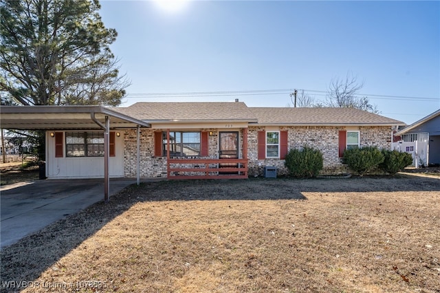 ranch-style home with a front lawn and a carport