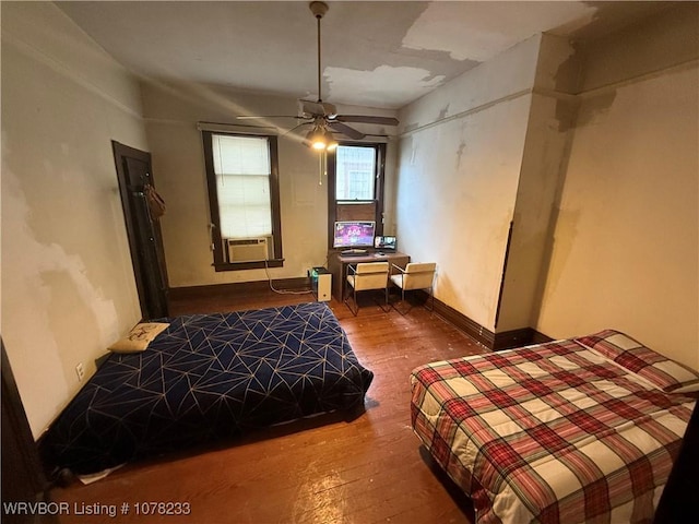 bedroom with ceiling fan, cooling unit, and wood-type flooring