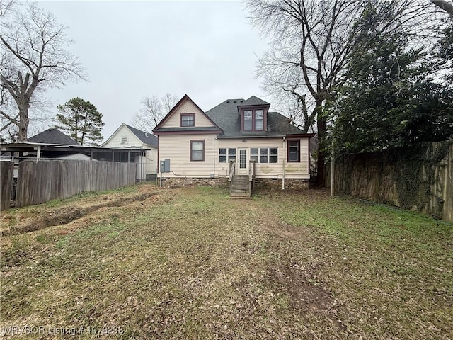 rear view of house with a lawn