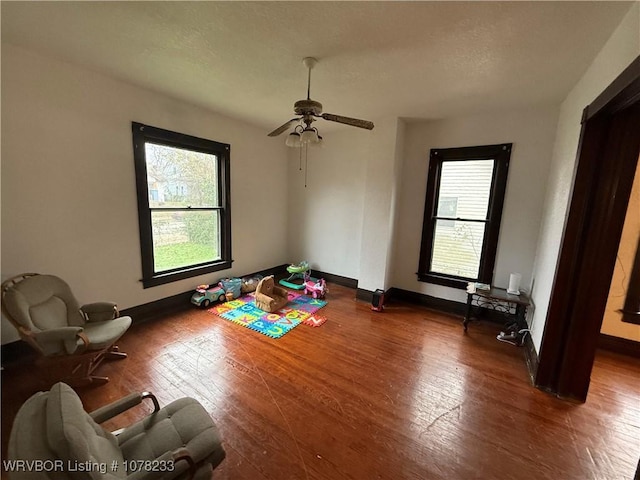 interior space with wood-type flooring and ceiling fan