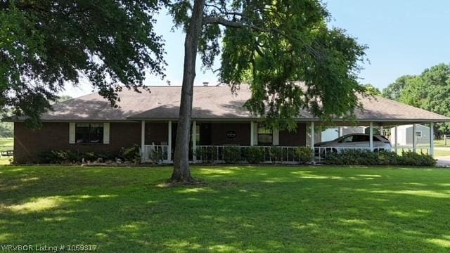 ranch-style house with a front yard and a carport