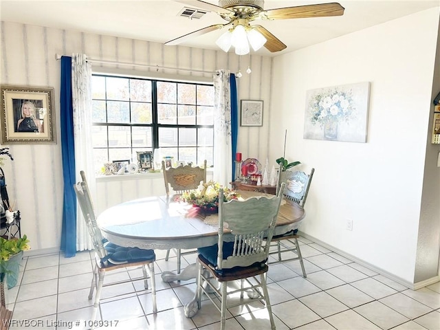 tiled dining area with ceiling fan