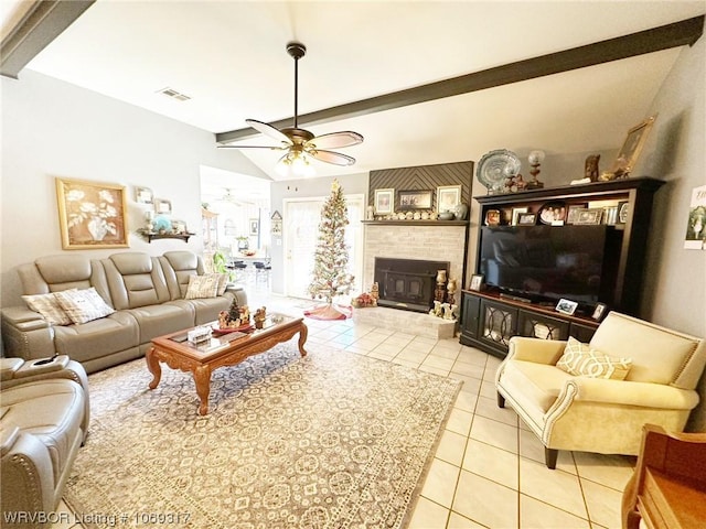 living room featuring vaulted ceiling with beams, ceiling fan, a fireplace, and light tile patterned floors