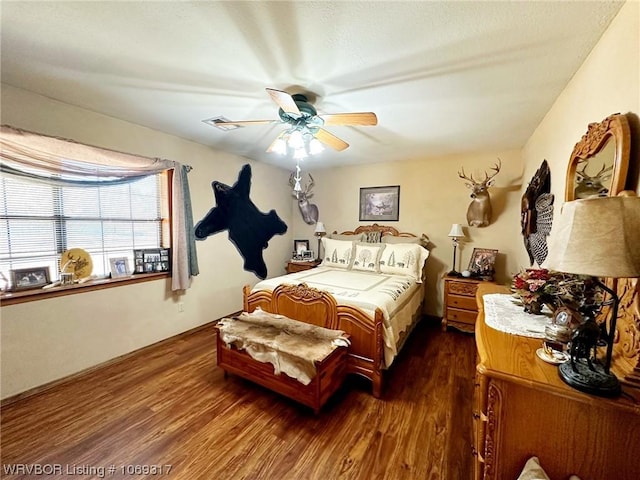 bedroom with dark hardwood / wood-style floors and ceiling fan