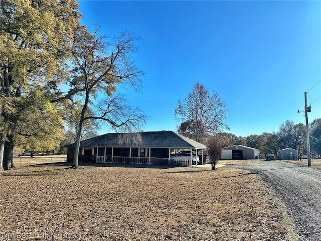 view of front of property with a porch and a carport