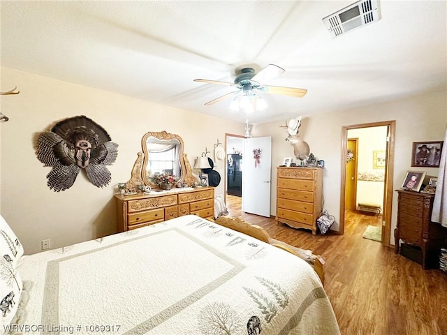 bedroom with ensuite bathroom, ceiling fan, and light hardwood / wood-style floors