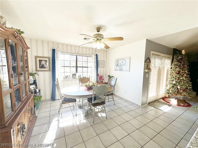 tiled dining area with ceiling fan