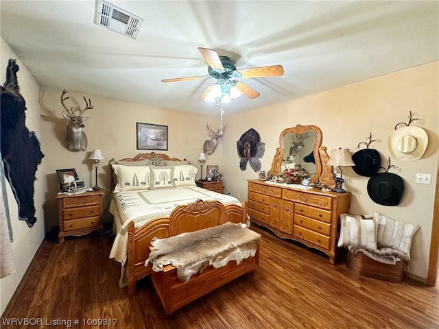 bedroom with ceiling fan and dark hardwood / wood-style flooring