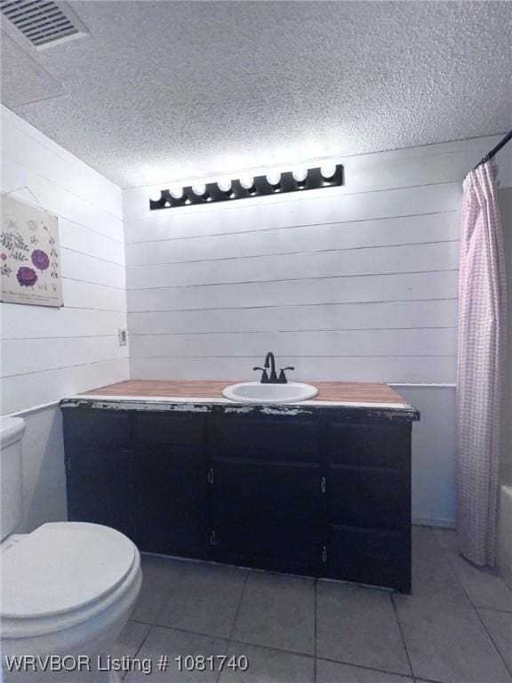 2015 Woodwind Way, Van Buren, AR 72956 - full bathroom with vanity, tile patterned floors, a textured ceiling, and wooden walls