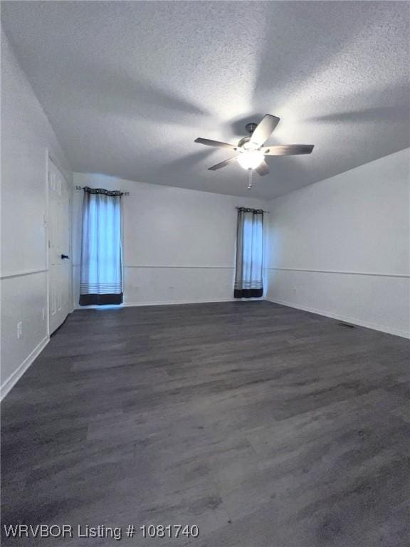 2015 Woodwind Way, Van Buren, AR 72956 - spare room featuring a textured ceiling, a ceiling fan, and dark wood finished floors
