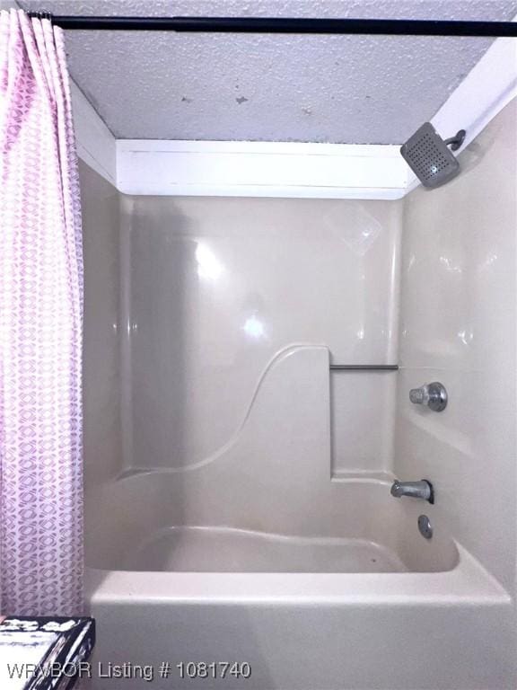 2015 Woodwind Way, Van Buren, AR 72956 - bathroom featuring shower / tub combo and a textured ceiling