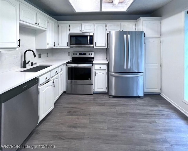 2015 Woodwind Way, Van Buren, AR 72956 - kitchen featuring appliances with stainless steel finishes, white cabinets, decorative backsplash, and light countertops