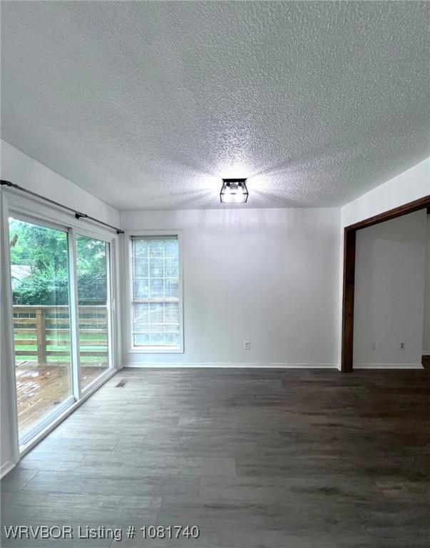 2015 Woodwind Way, Van Buren, AR 72956 - empty room with wood finished floors and a textured ceiling