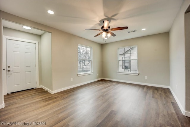 unfurnished room with hardwood / wood-style floors and ceiling fan