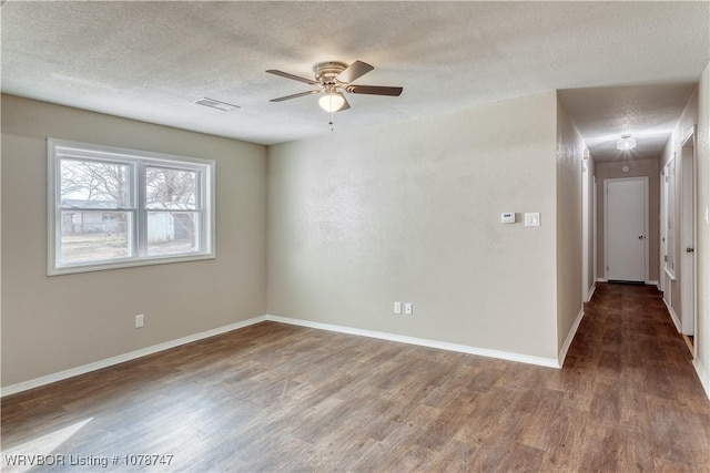 spare room featuring ceiling fan, hardwood / wood-style floors, and a textured ceiling