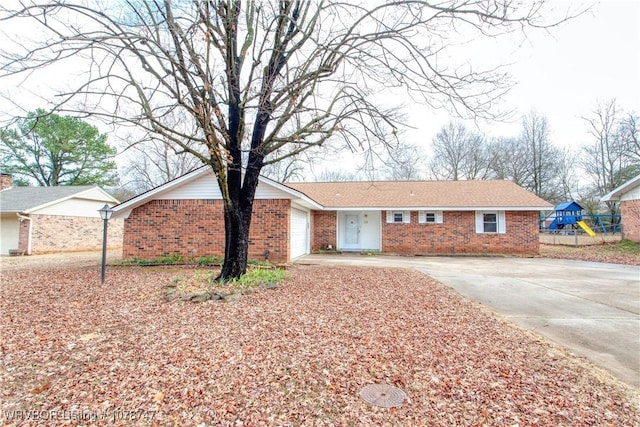 ranch-style home with a garage and a playground